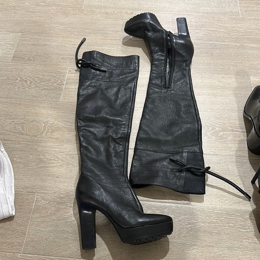 Basically unworn. Black leather thigh high boots with platform and lug sole.